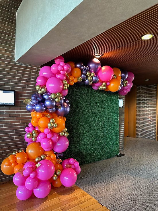 Hedge wall backdrop rental Chicago with colorful balloon arch birthday party