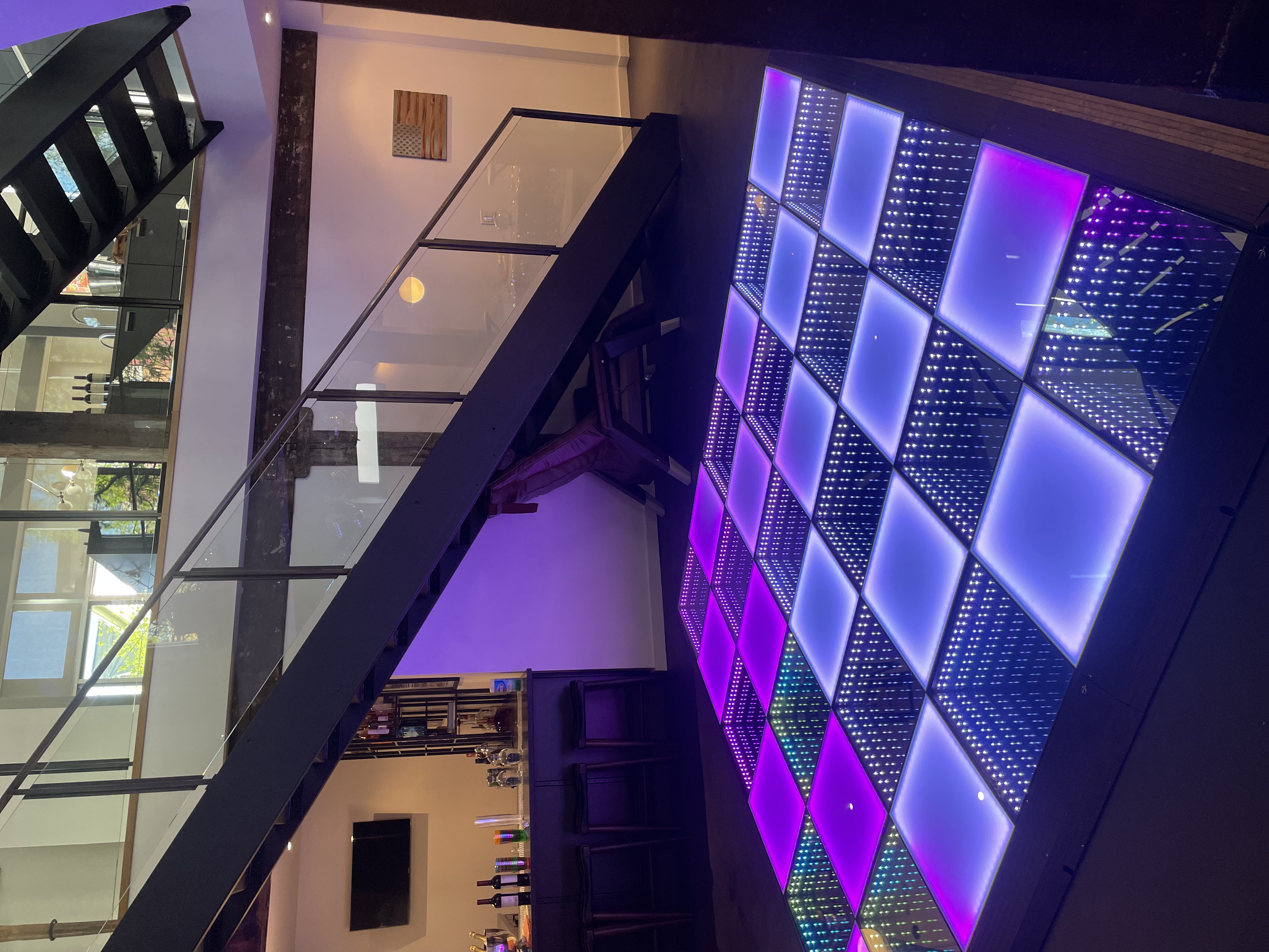 Purple and white infinity-mirror LED dance floor glowing at an indoor event venue in Chicago