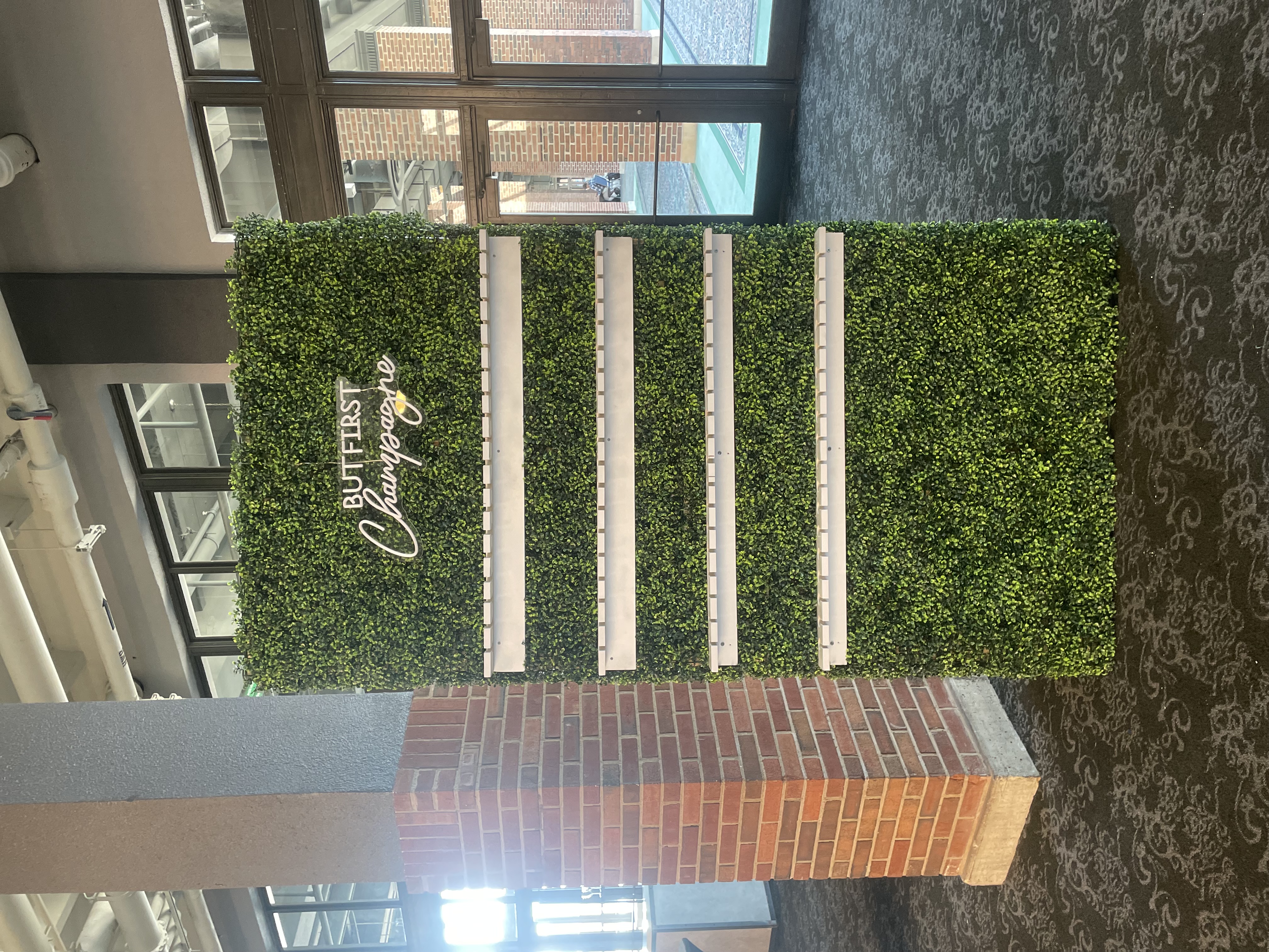Boxwood champagne wall rental at Navy Pier Grand Ballroom Chicago — tiered prosecco display with But First Champagne neon sign