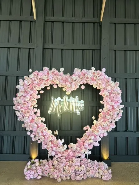 Pink flower heart arch rental Chicago — barn wedding venue with Mr & Mrs neon sign