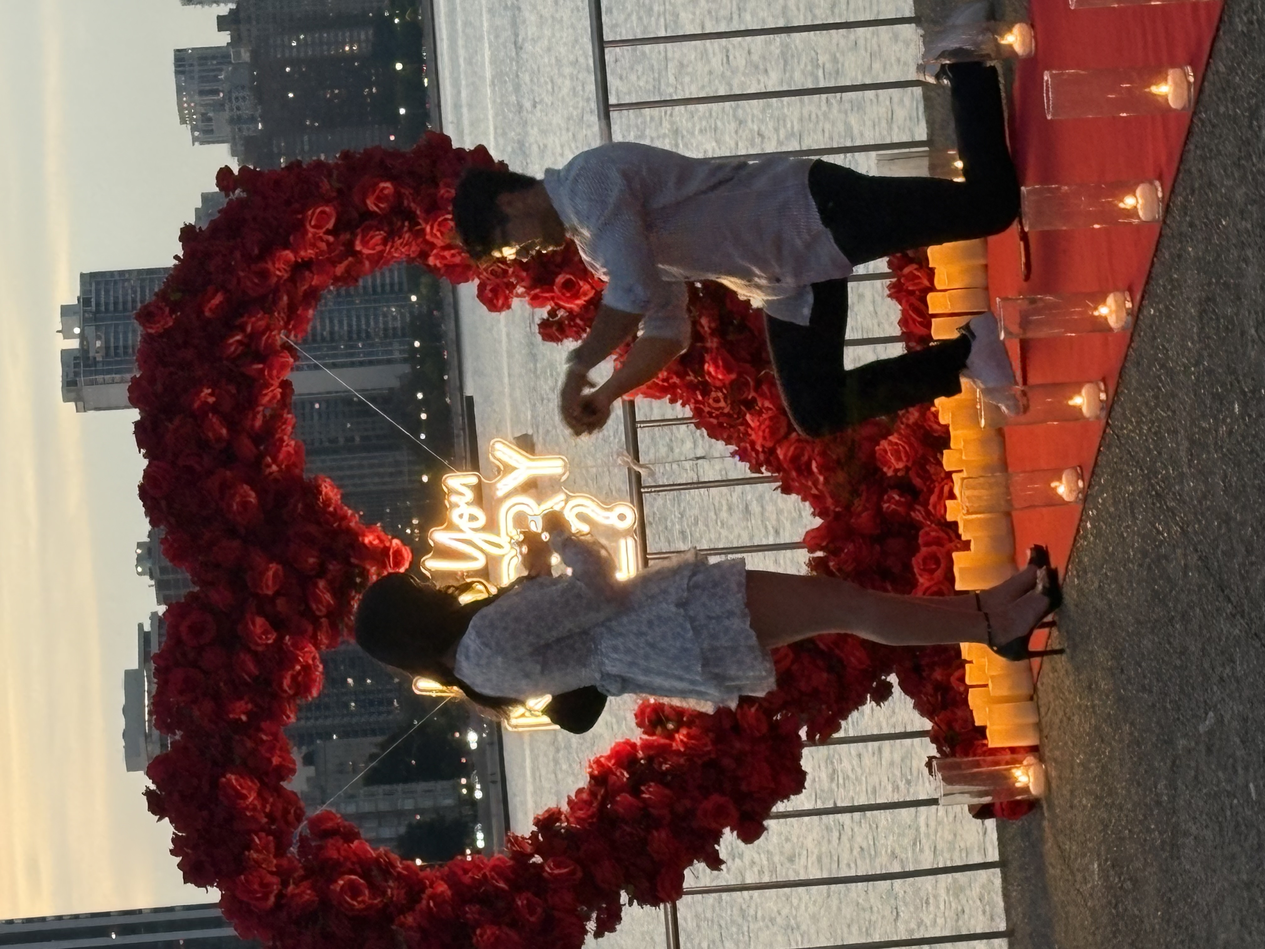 Proposal decor Chicago — creative proposal setup with flower wall backdrop and Will You Marry Me neon sign