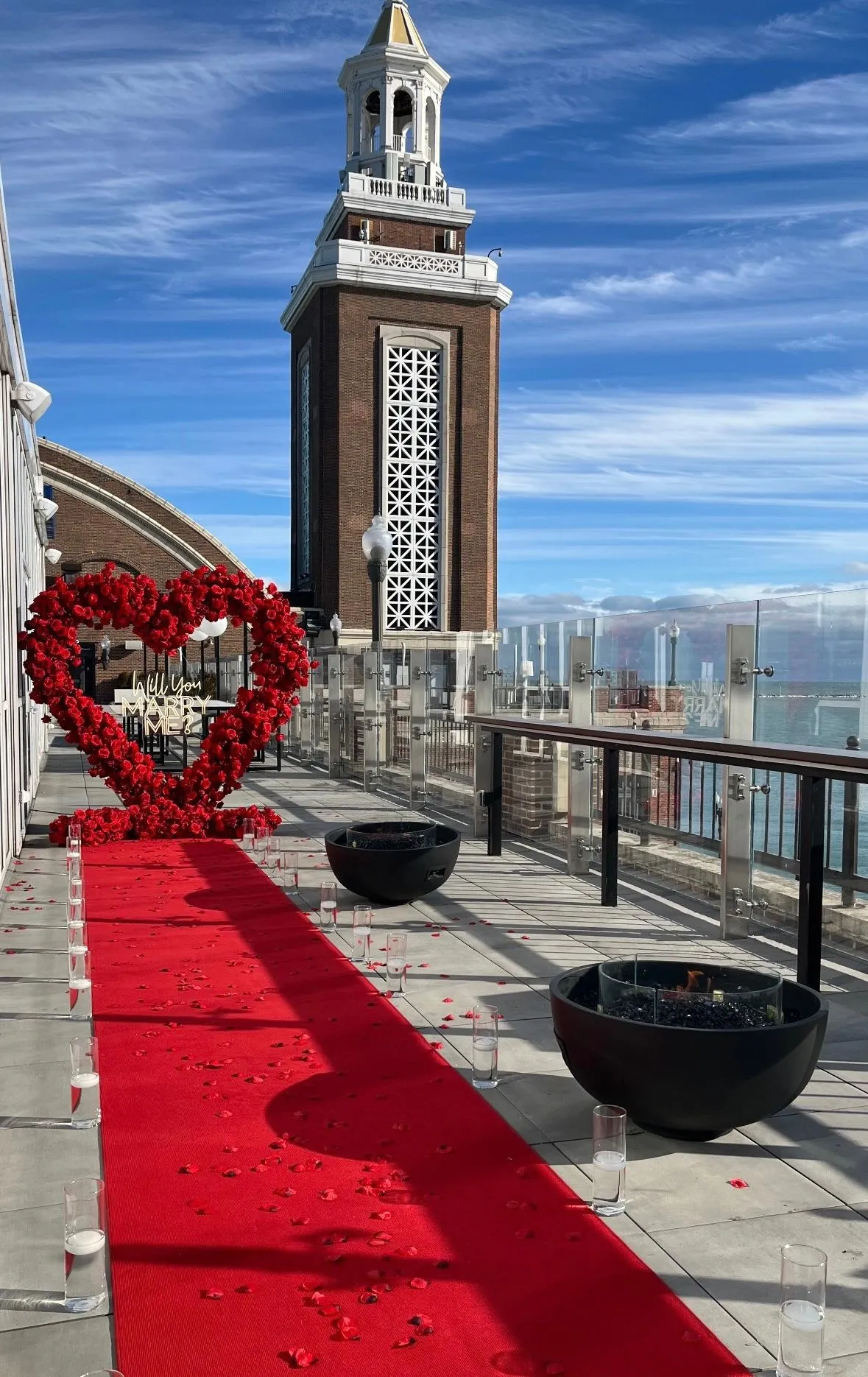 Marry Me letters rental Chicago — rooftop proposal rentals near me featuring light-up marquee letters and heart arch with red roses