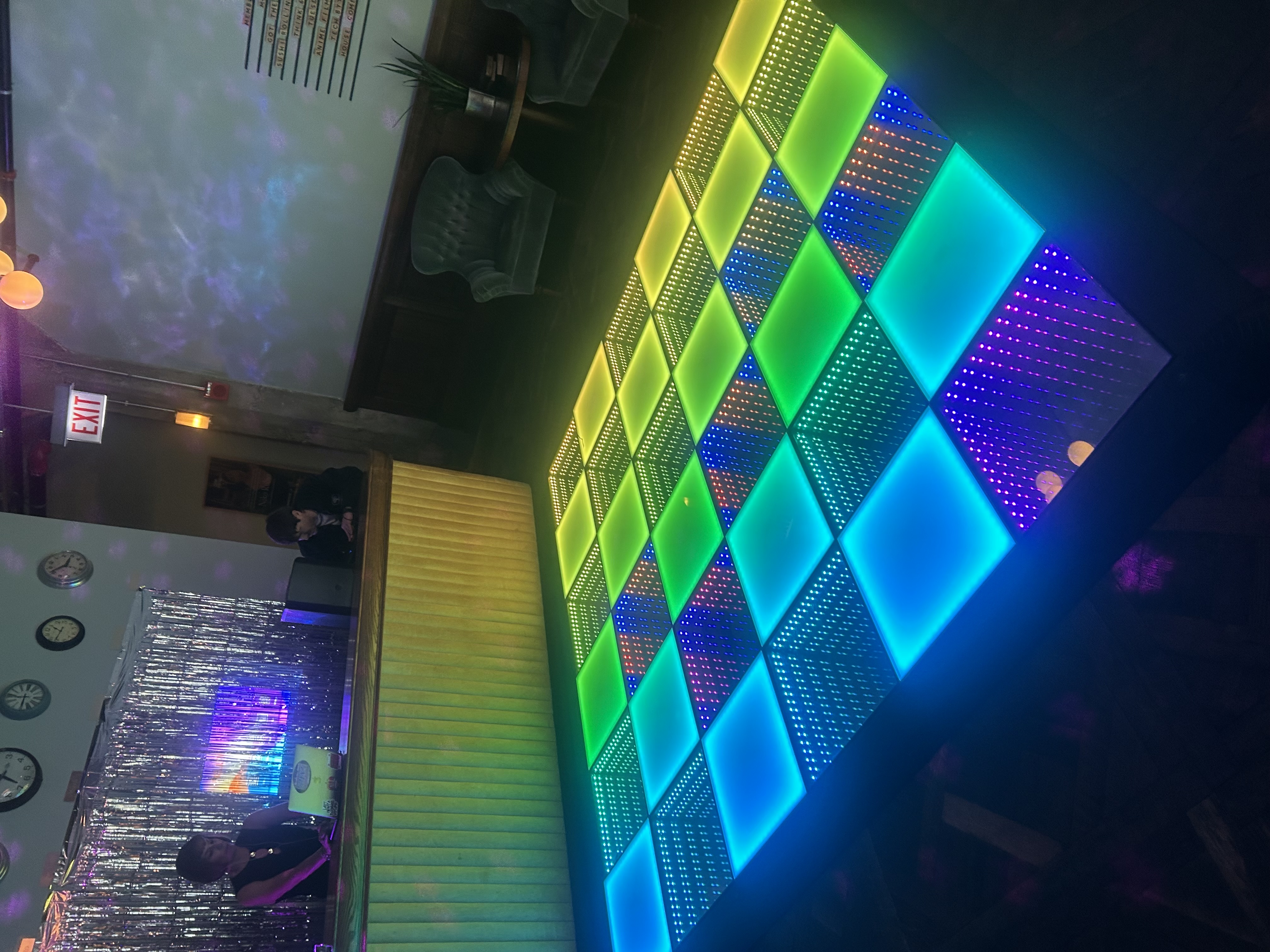 10x10 LED dance floor rental Chicago — blue, green and yellow light up infinity panels at lounge event