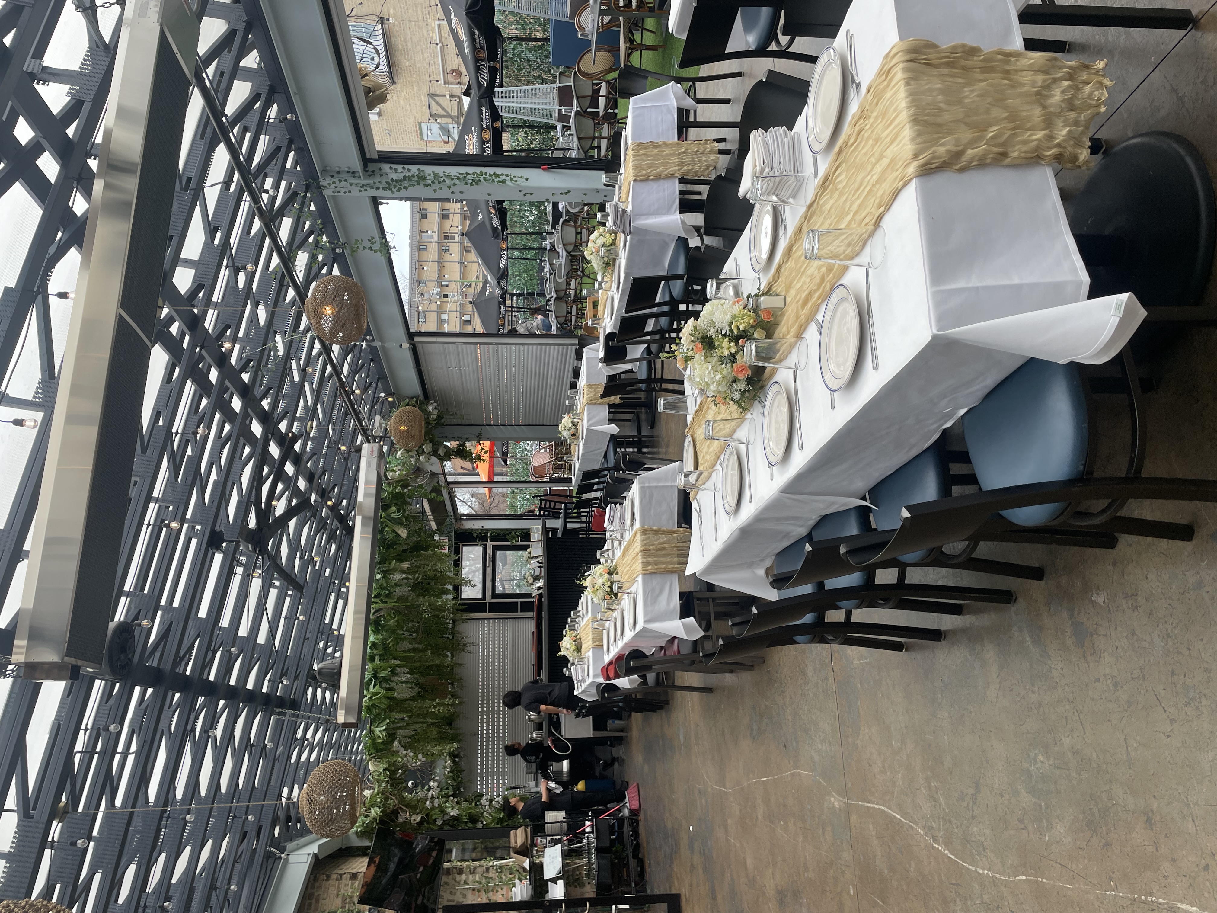Indoor dining room at Zia's Sofial Park Ridge IL set up for a bridal shower with gold table runners and floral centerpieces
