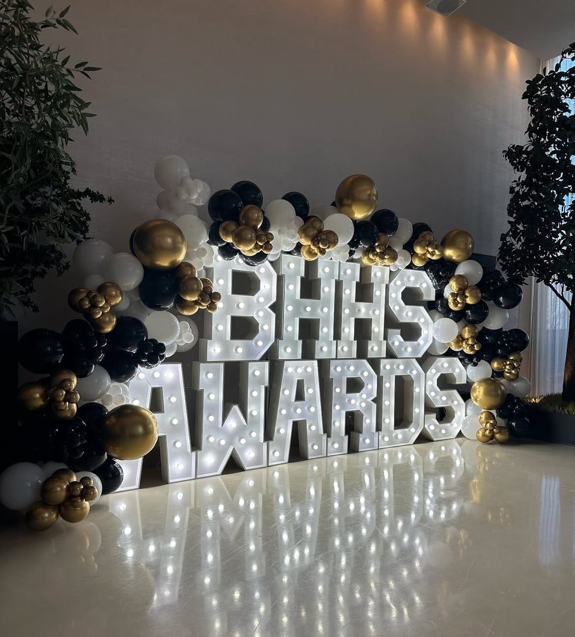Corporate event marquee letters rental Chicago — illuminated BHHS Awards letters with black gold white balloon garland