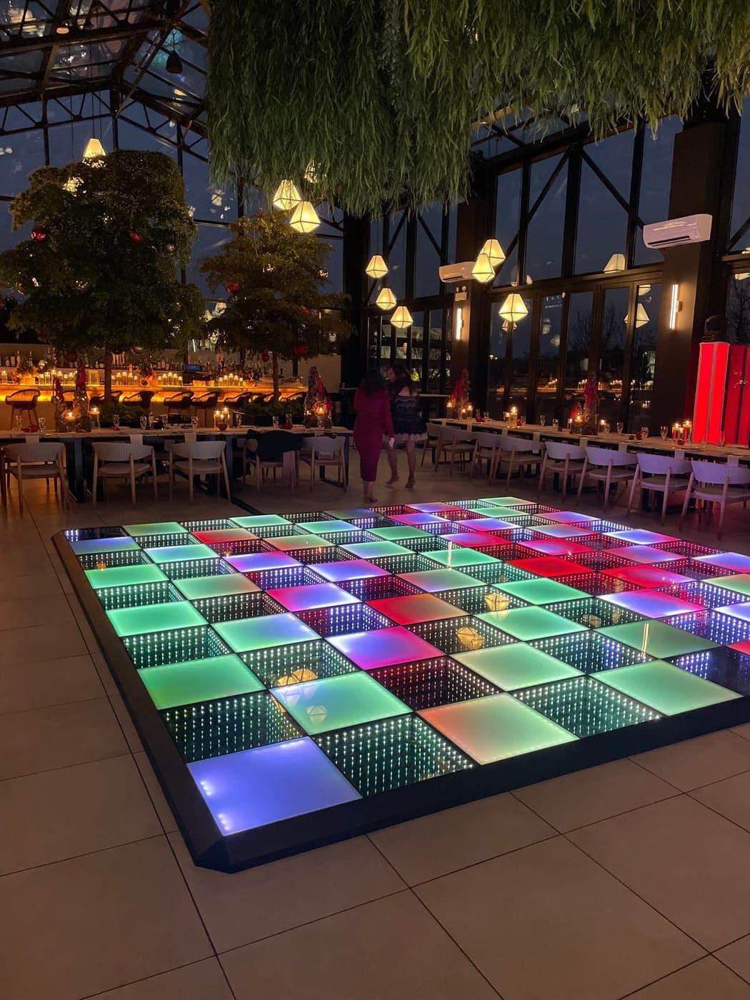 Homecoming LED dance floor rental in Chicago with multicolor infinity panels in a glass-walled event hall