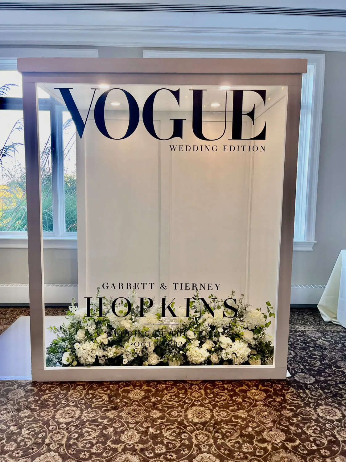 Chicago Flower Wall magazine photo booth rental with a personalized wedding cover and white floral arrangement — rental inspiration for Hoffman Estates