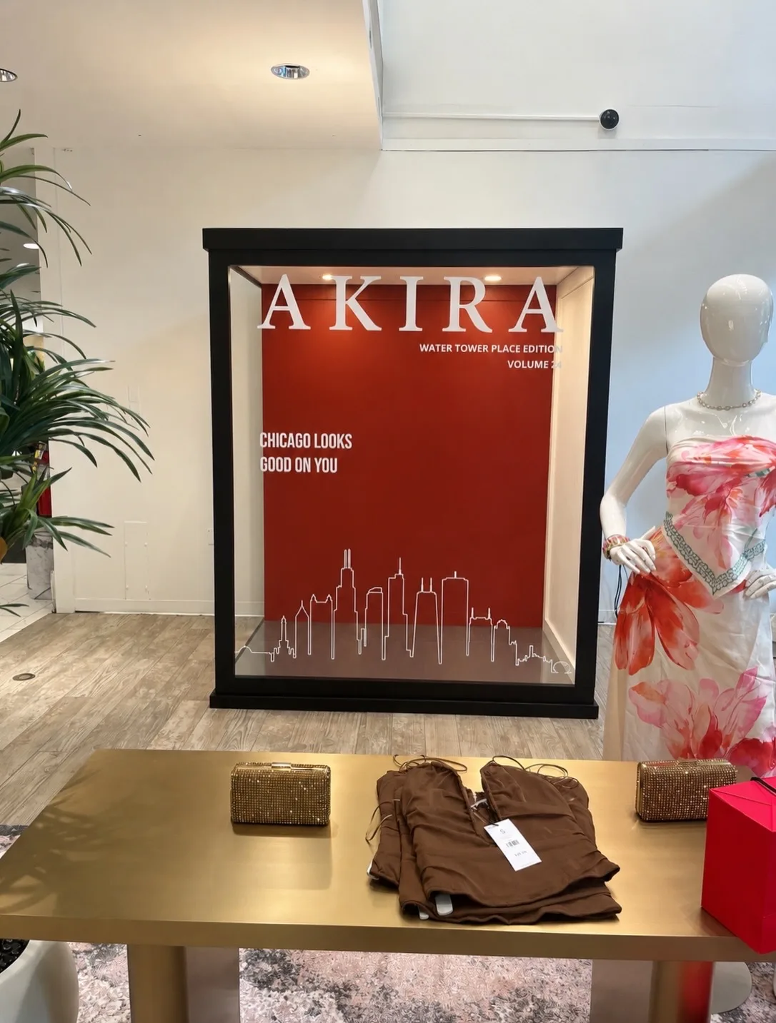 Black Chicago Flower Wall magazine photo booth with an AKIRA Water Tower Place cover and Chicago skyline design — rental inspiration for Oak Brook