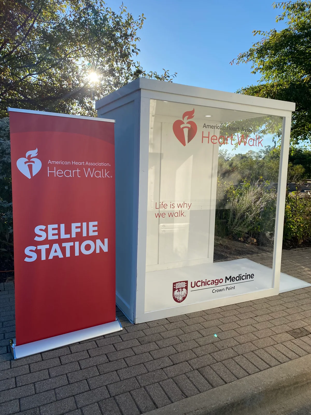 Chicago Flower Wall magazine photo booth rental with American Heart Association Heart Walk branding beside a selfie station sign — rental inspiration for Wheaton