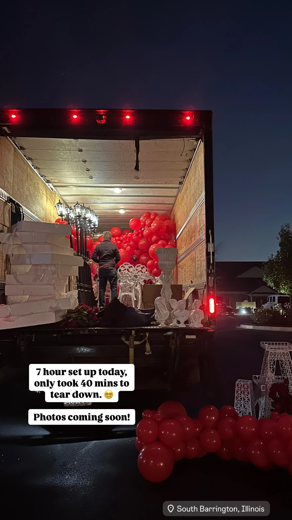 Balloon garland rental in South Barrington — red balloon garlands, lamp posts, statues, and an Eiffel Tower prop being loaded into the truck after a seven-hour setup