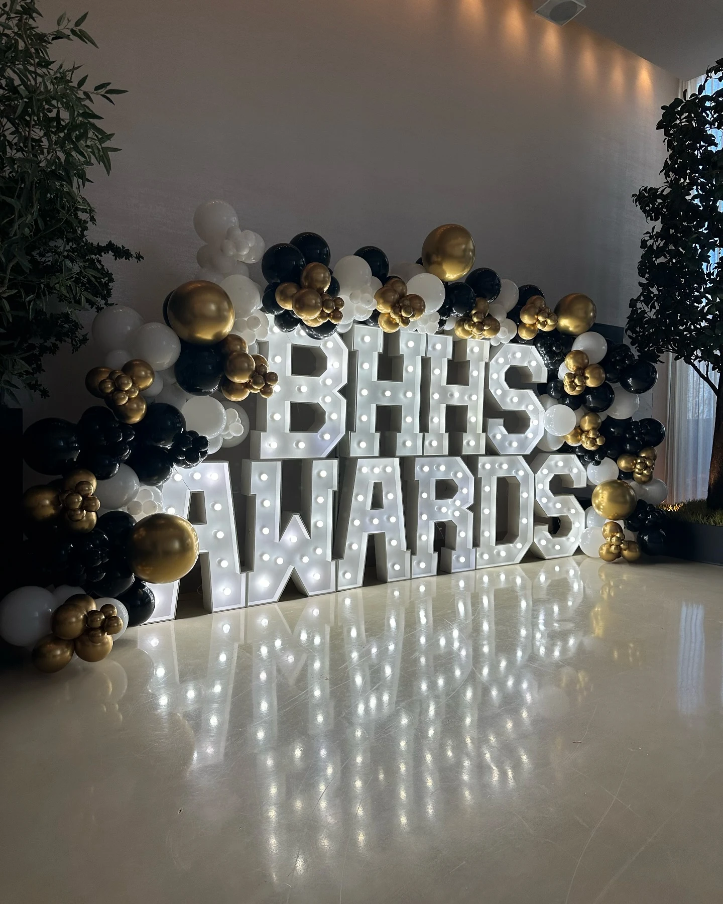 Marquee letter rental in Chicago — stacked white bulb letters spelling BHHS AWARDS wrapped in black, white and gold balloons at RPM Events Chicago