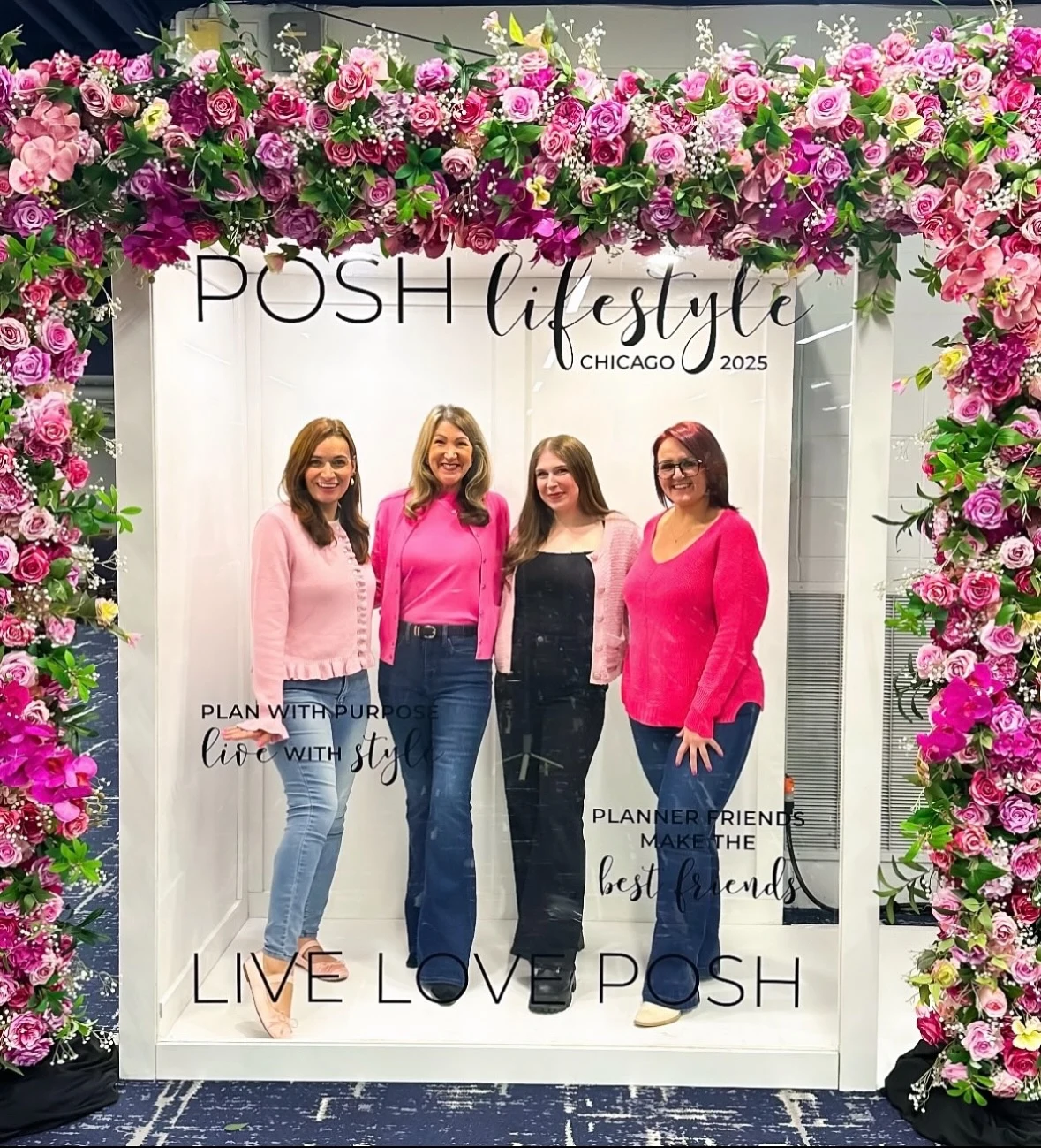 Magazine photo booth rental in Chicago with a POSH Lifestyle Chicago 2025 magazine cover photo booth framed in pink roses and four conference attendees posing inside