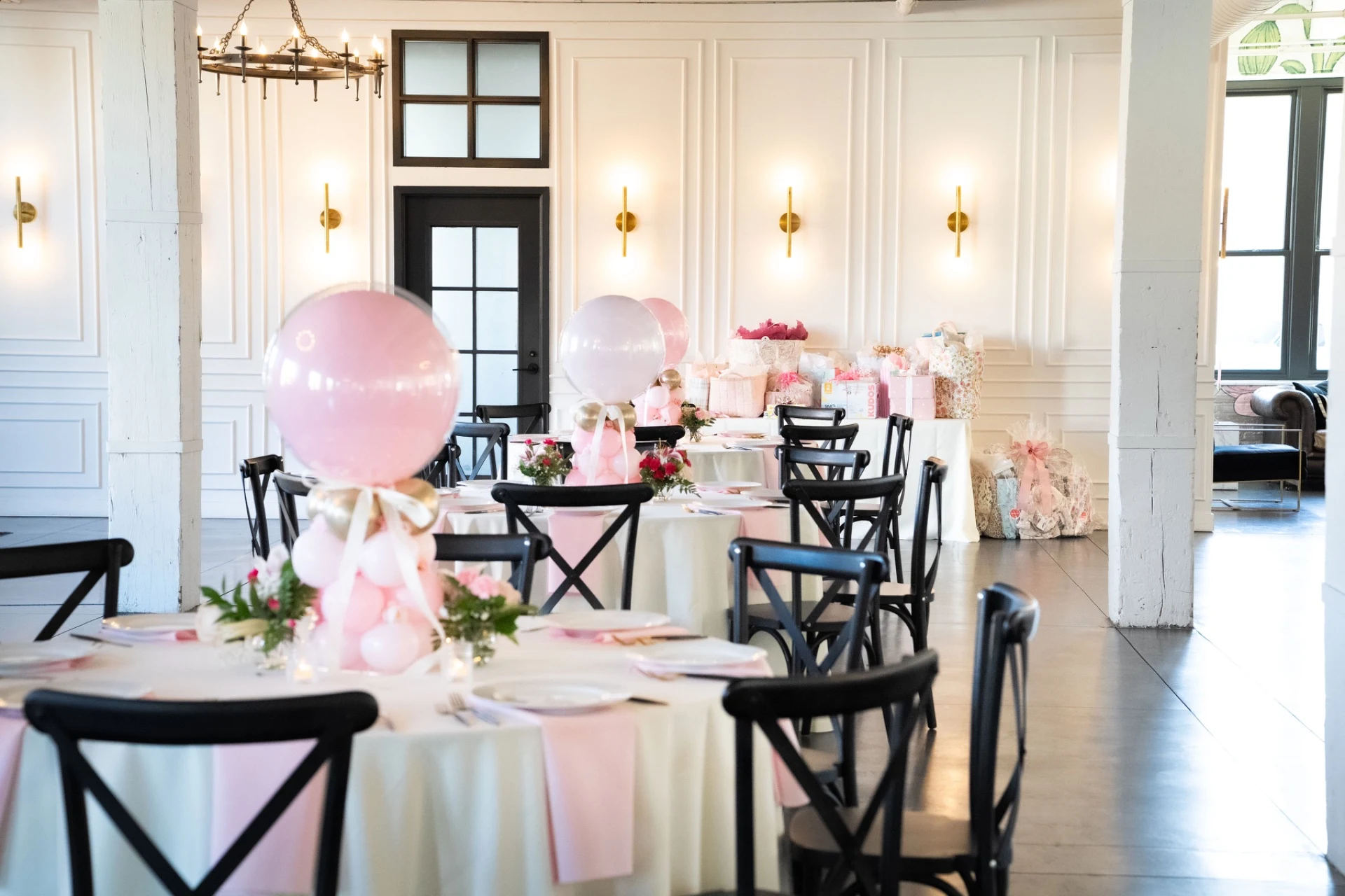 balloon arch and centerpiece rentals in Naperville area — tall pink balloon centerpieces over round guest tables at a baby shower