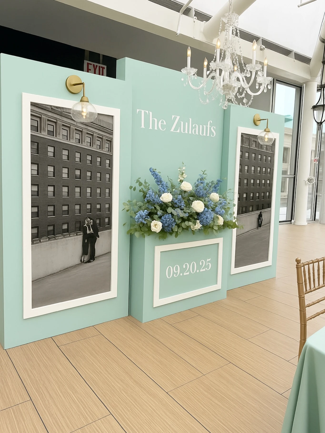 wedding welcome sign rental in Chicago — three-piece mint welcome wall with framed black-and-white couple photos, The Zulaufs 09.20.25 lettering and a blue and white flower box at Offshore Rooftop on Navy Pier