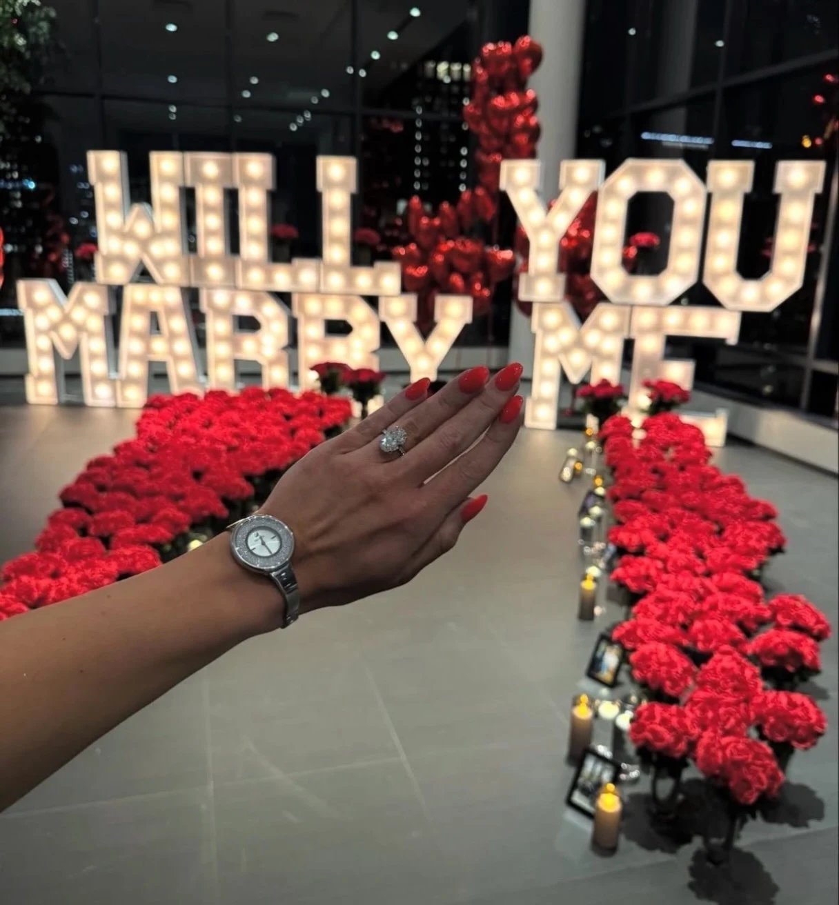 Marquee letter rental in Chicago — light-up Will You Marry Me letters over a red rose walkway with a diamond ring in the foreground