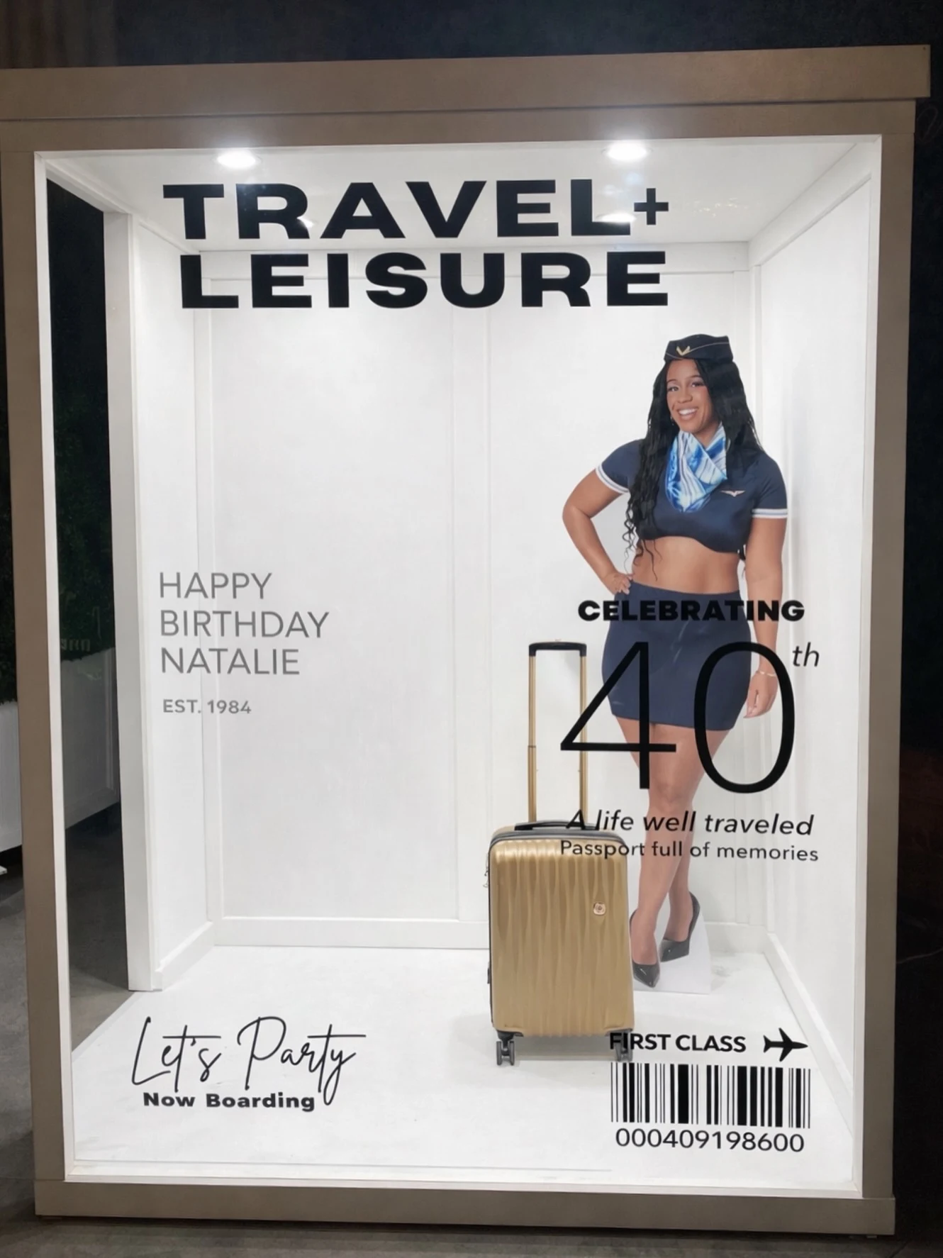 Magazine photo booth rental in Chicago with a custom Travel and Leisure cover for a travel-themed 40th birthday and a gold suitcase prop.