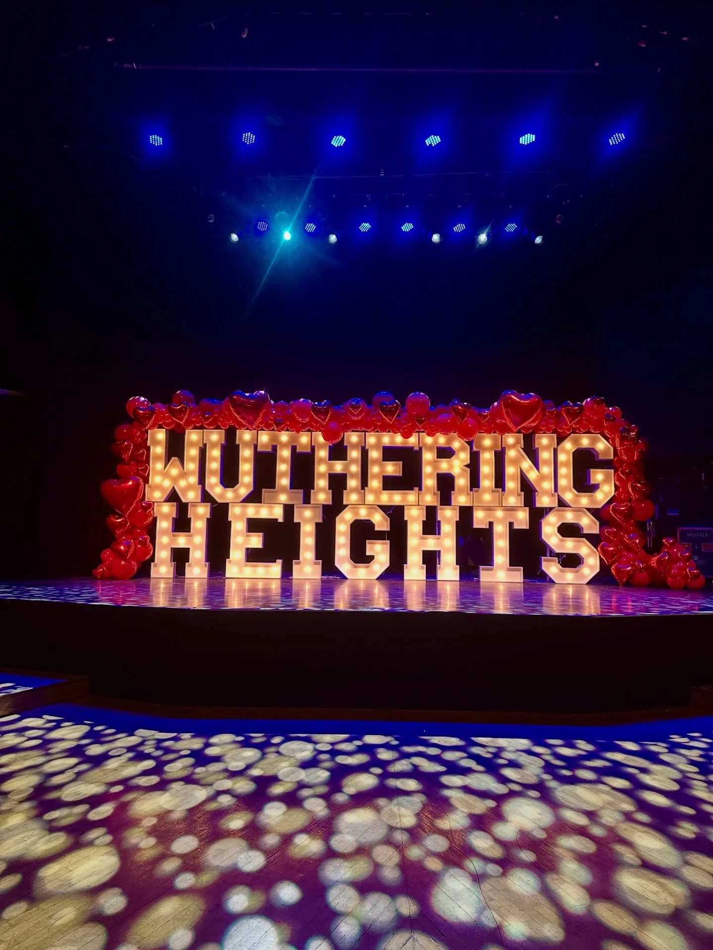 Marquee letter rental in Chicago with giant illuminated letters spelling Wuthering Heights on the Park West stage framed by red heart balloons