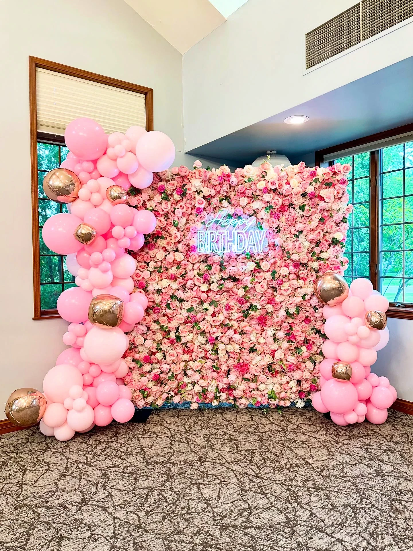 pink flower wall rental in Chicago — a full wall of blush and pink roses with a neon Happy Birthday sign and pink balloon garlands with rose-gold orb balloons at a Sweet 16