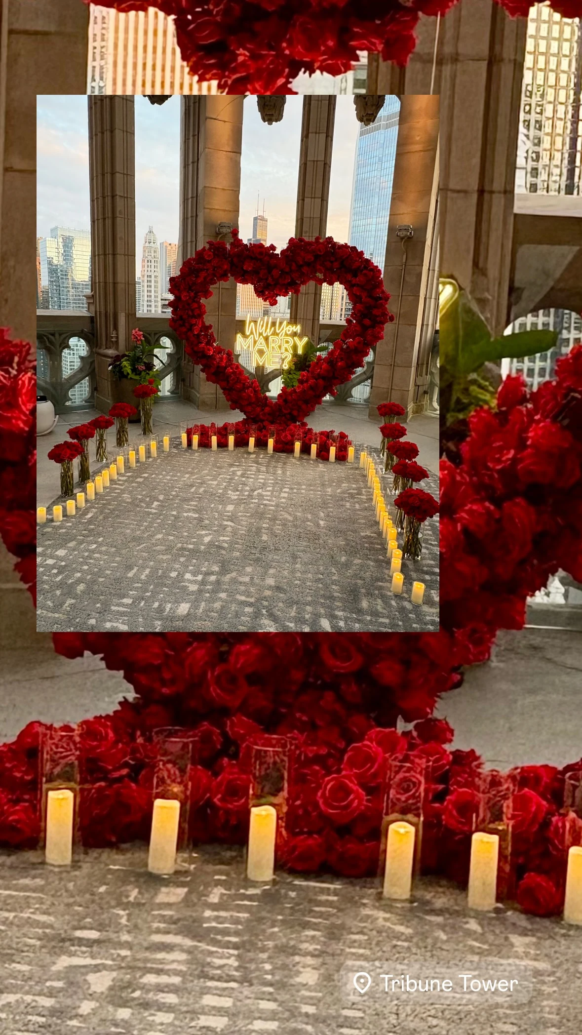Proposal rental in Chicago — red rose heart arch with a Will You Marry Me neon sign on the Tribune Tower crown terrace above Michigan Avenue